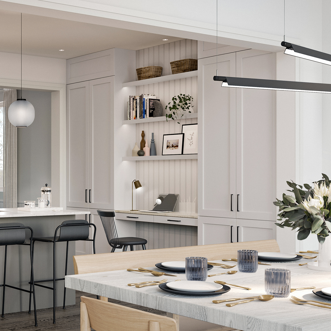 Open dining area leading into kitchen with barstools, and walldesk. Primarily white colouring and panelling.